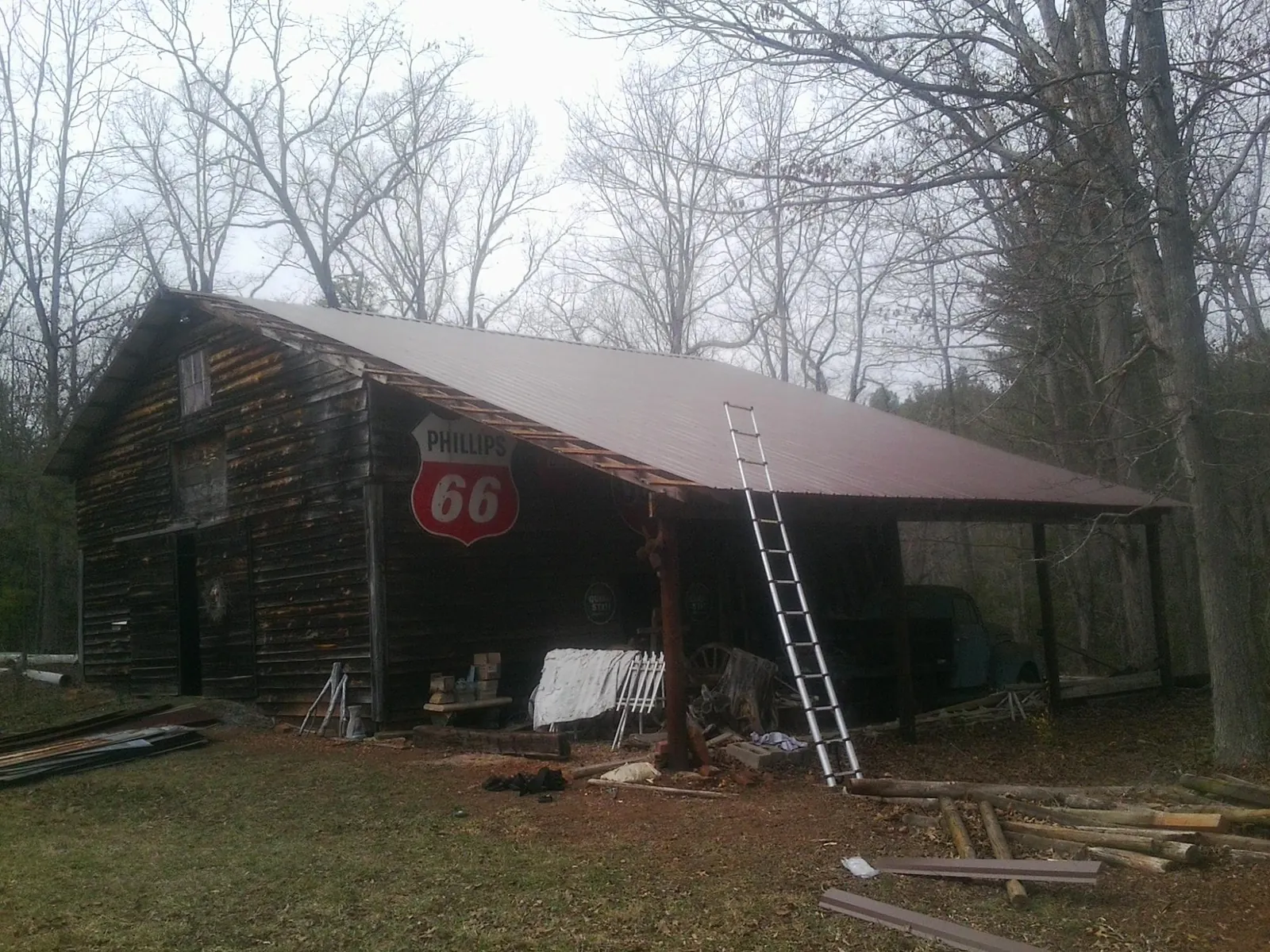 New metal roof on an open sided timber barn with a vintage sign in Hillsborough